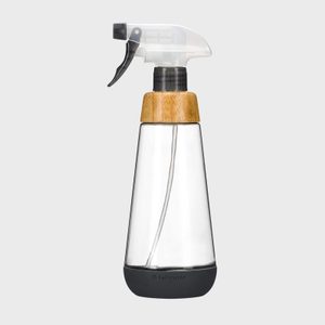 A clear spray bottle with a black nozzle and bamboo detail stands upright on a plain gray background. Text reads â€œfull circle.â€