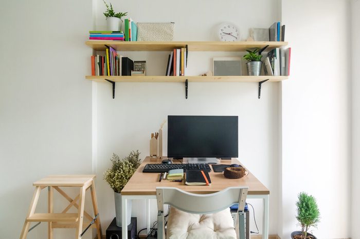 Home office working space. wooden shelf with white wall