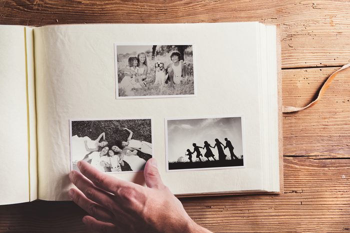 Fathers day composition - photo album with a black and white photos. Studio shot on wooden background.