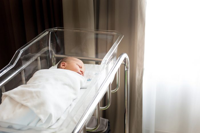 Newborn baby in his baby coat in Hospital after delivery