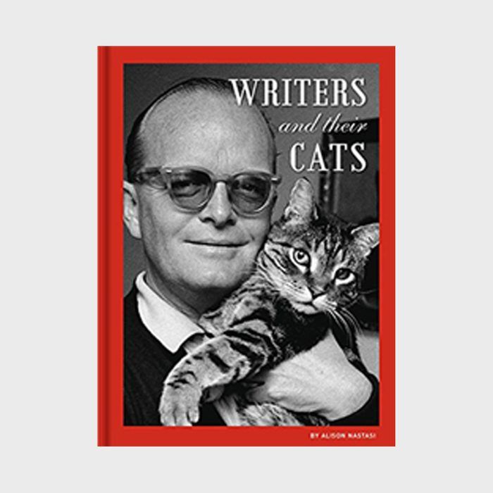 A man holding a tabby cat smiles in a black-and-white photo with a red border. Text: 