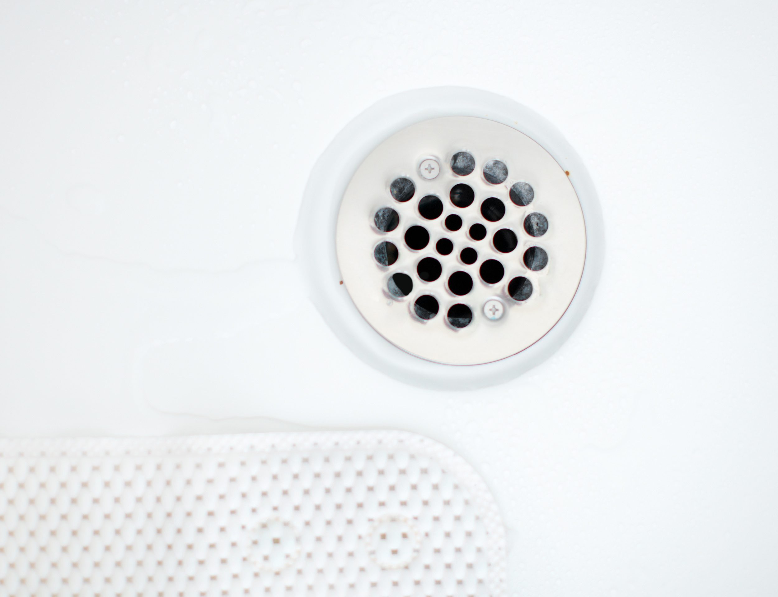White bath. Close up. Drain