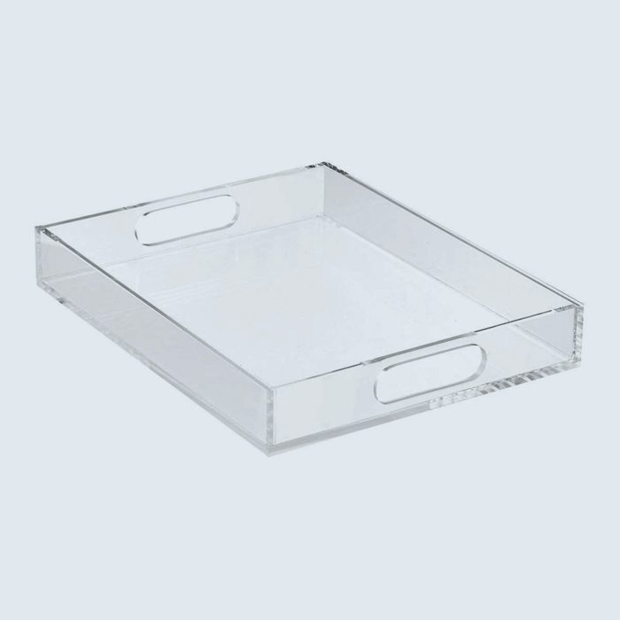 Clear rectangular acrylic tray with cut-out handles on two sides, resting on a light, plain background.