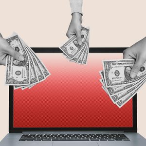 Hands holding dollar bills extend towards a laptop screen, set against a plain background.