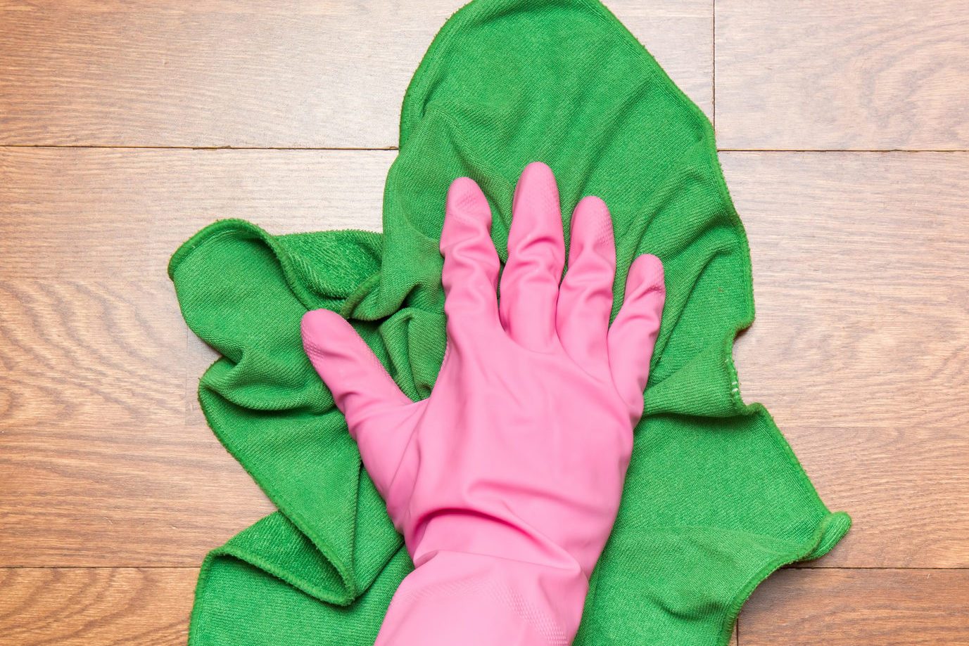 Wooden floors cleaning with rag in the room.