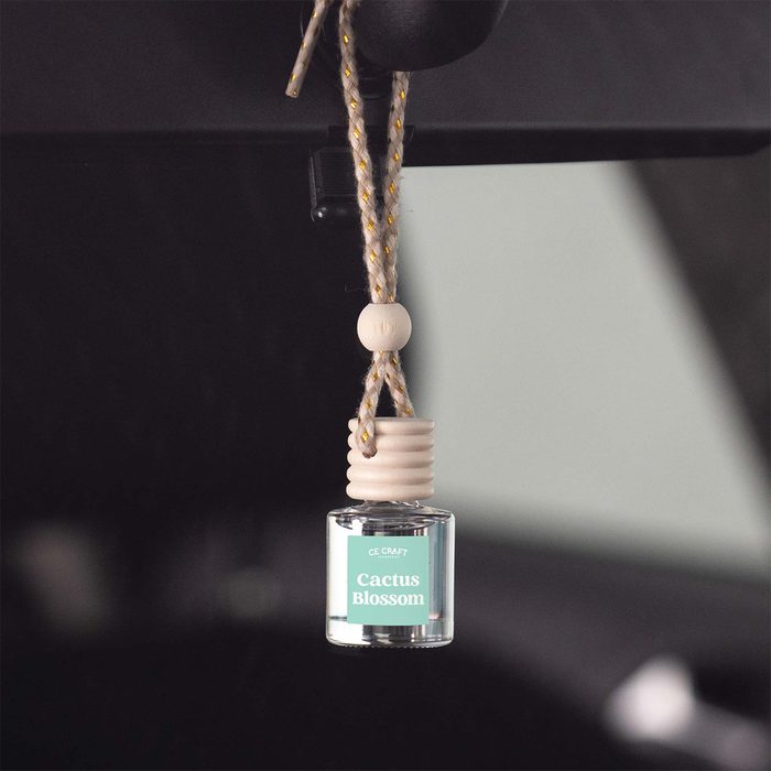 Air freshener hangs suspended inside a vehicle, labeled 