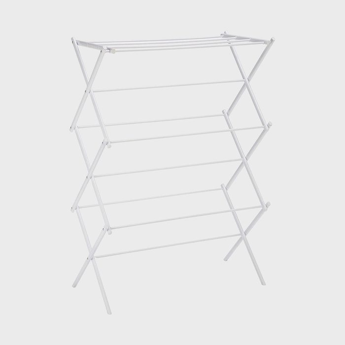 Drying rack stands unfolded, displaying multiple horizontal bars for hanging clothes in a plain, white background.