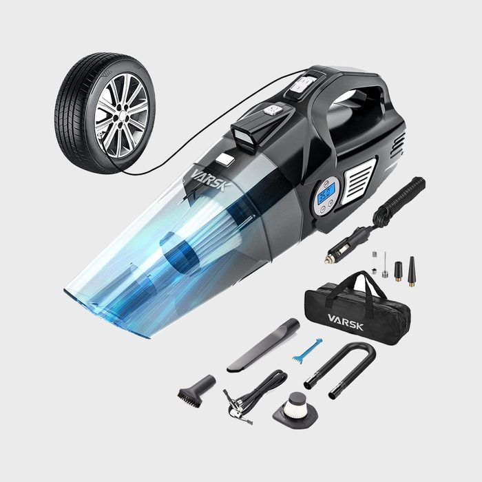 Handheld vacuum inflates tire, displaying a  digital gauge. Accessories, including a brush and carrying case, are arranged below on a plain background.