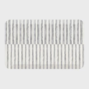 Rectangular rug features vertical gray and white stripes, creating a simple geometric pattern, set against a plain, light gray background.