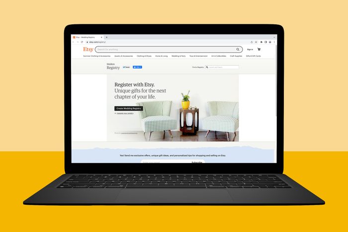 Laptop displaying an Etsy wedding registry page shows chairs and table with framed text in a promotional setting.
