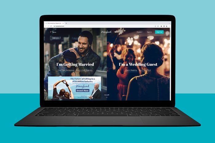 A laptop displays a website with sections for 