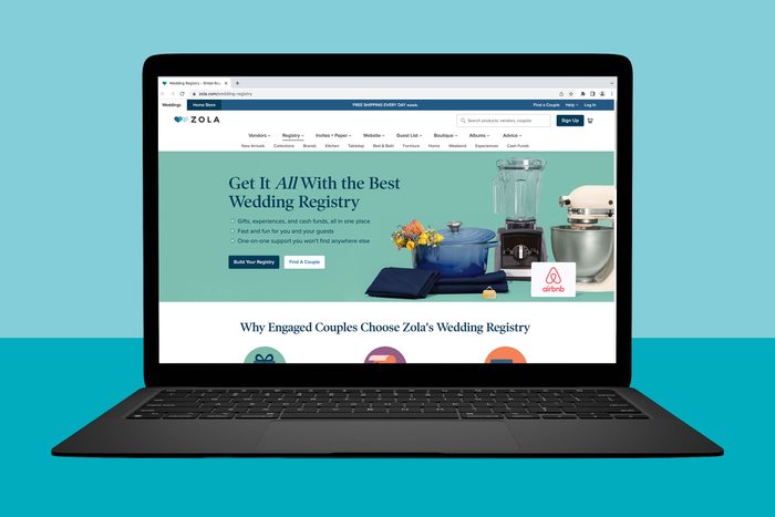 Laptop displays Zola wedding registry webpage, featuring household items like a blender and mixer, against a teal background. Text promotes wedding registry benefits.