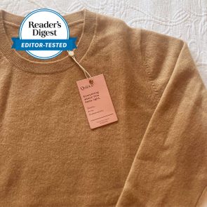 Sweater lies flat with a tag reading 