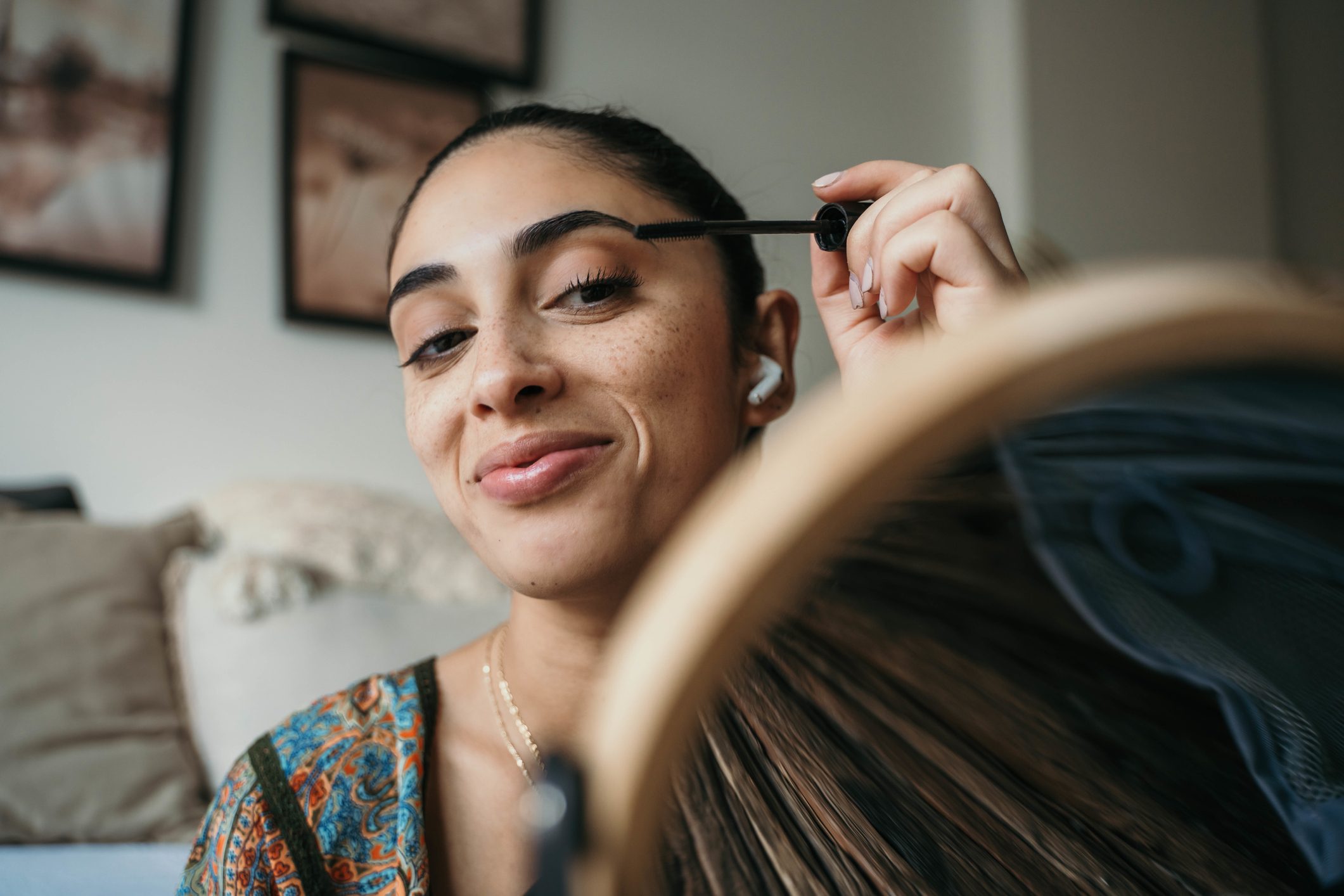 Beautiful woman using mascara.