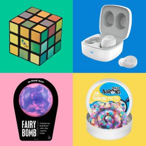 Rubikâ€™s Cube remains static on a green background. Earbuds sit in an open case on blue. Bath bomb packaged on pink. Putty in a tin on yellow.