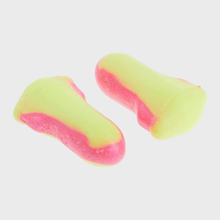 Two foam earplugs rest on a plain background, featuring a swirl of bright yellow and pink colors.