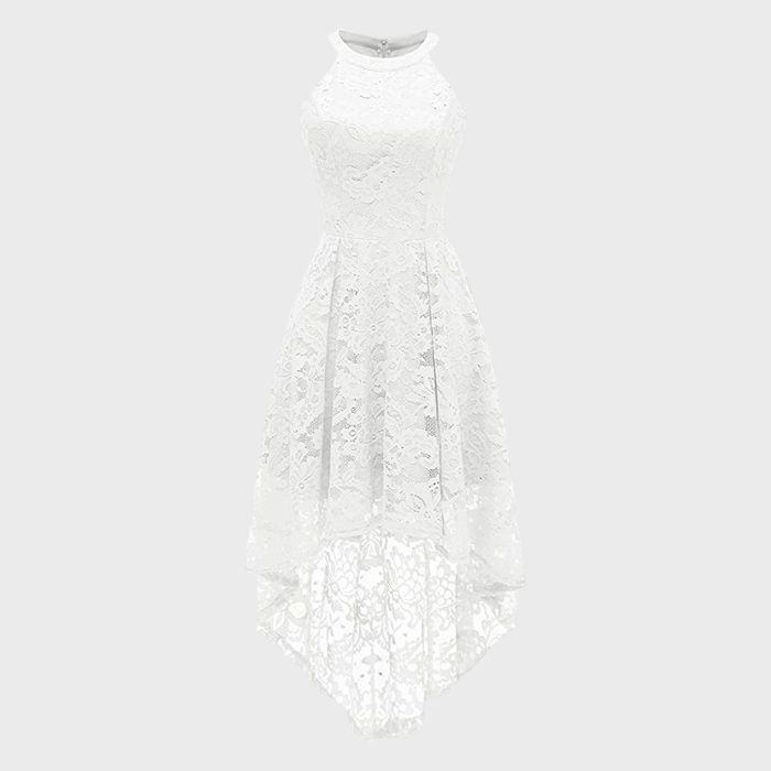 White lace dress hanging, showcasing high neckline and asymmetric hem, against a plain gray background.