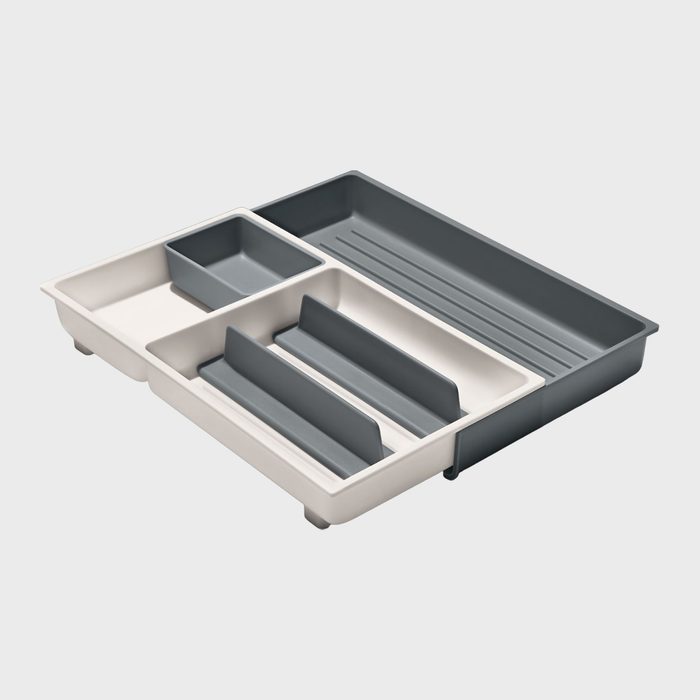 Cutlery tray with adjustable dividers, organizing compartments. Plastic with gray and white sections, set on a plain white background.
