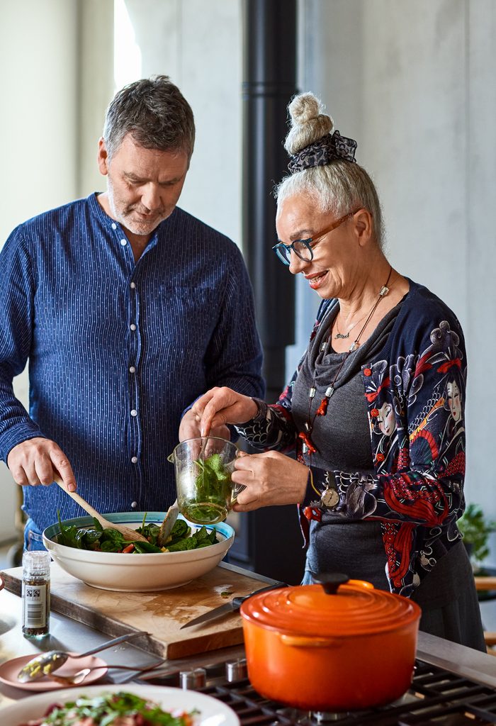 Mature man and senior woman making lunch