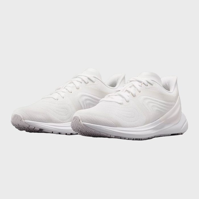 White athletic shoes, resting side by side, against a simple gray background.