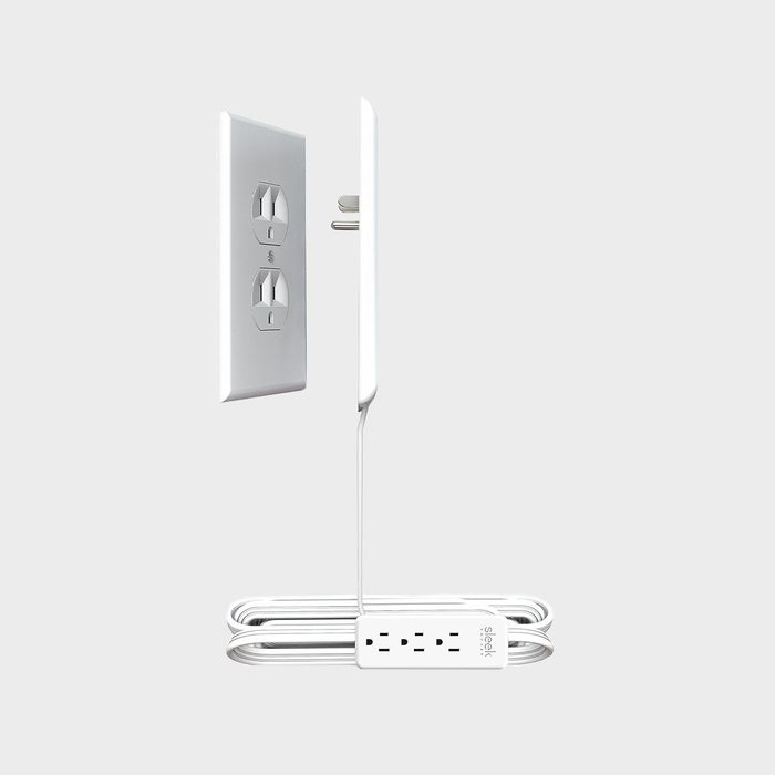 Power strip plugs into wall outlet, extending sideways with cable coiled neatly. Background is light gray. Text reads, 