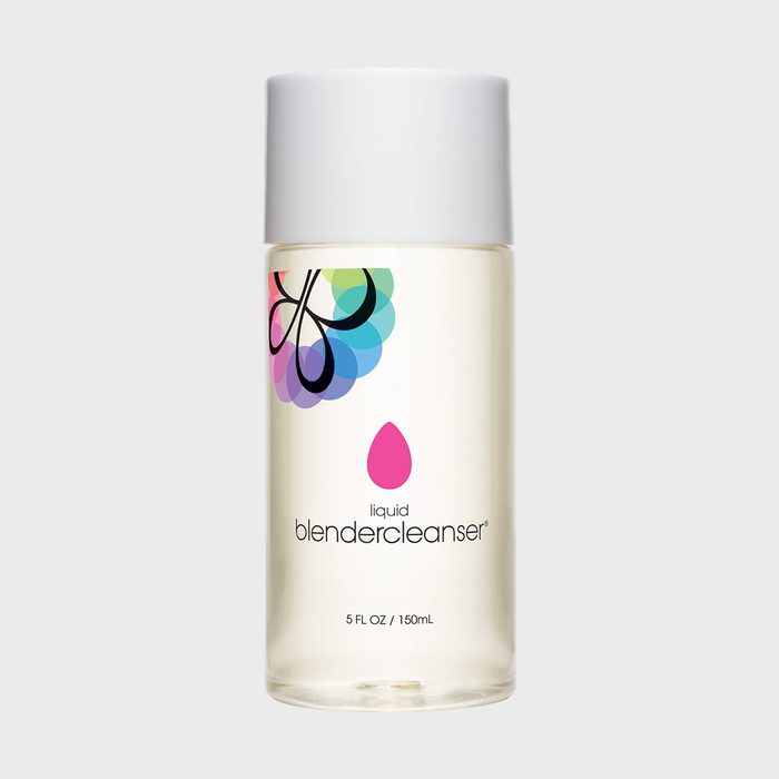 A clear bottle with a white cap displays colorful branding and text: 