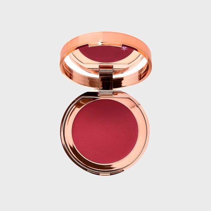 Compact blush reveals deep red powder with a reflective rose-gold case, set against a plain white background.