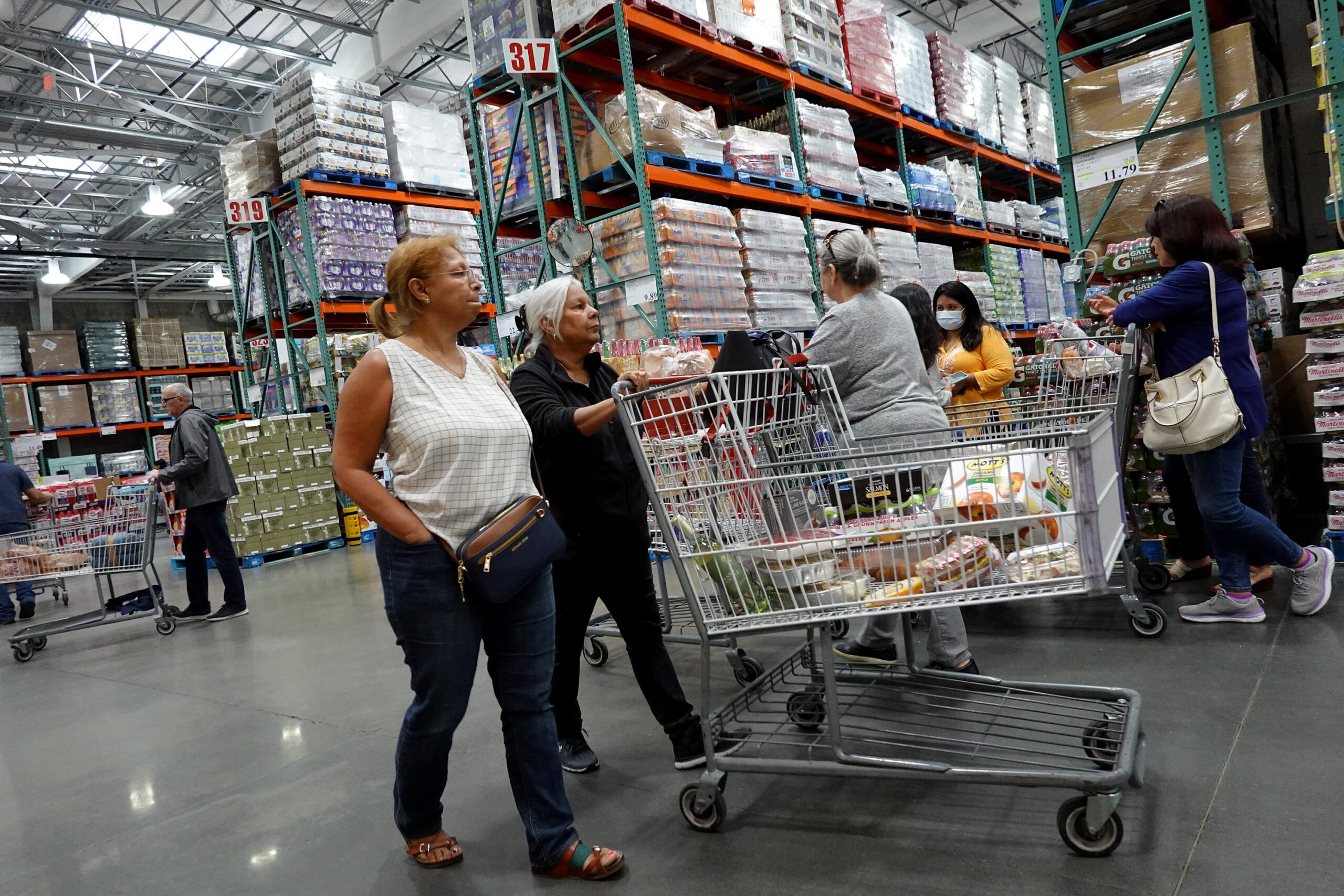 People pushing a grocery cart at Costco