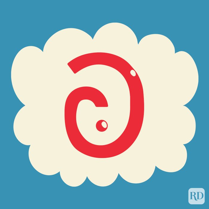 Sarcmark in the color red on a beige cloud on blue background.