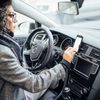 Woman Uses Navigation On Her Mobile Phone In The Car